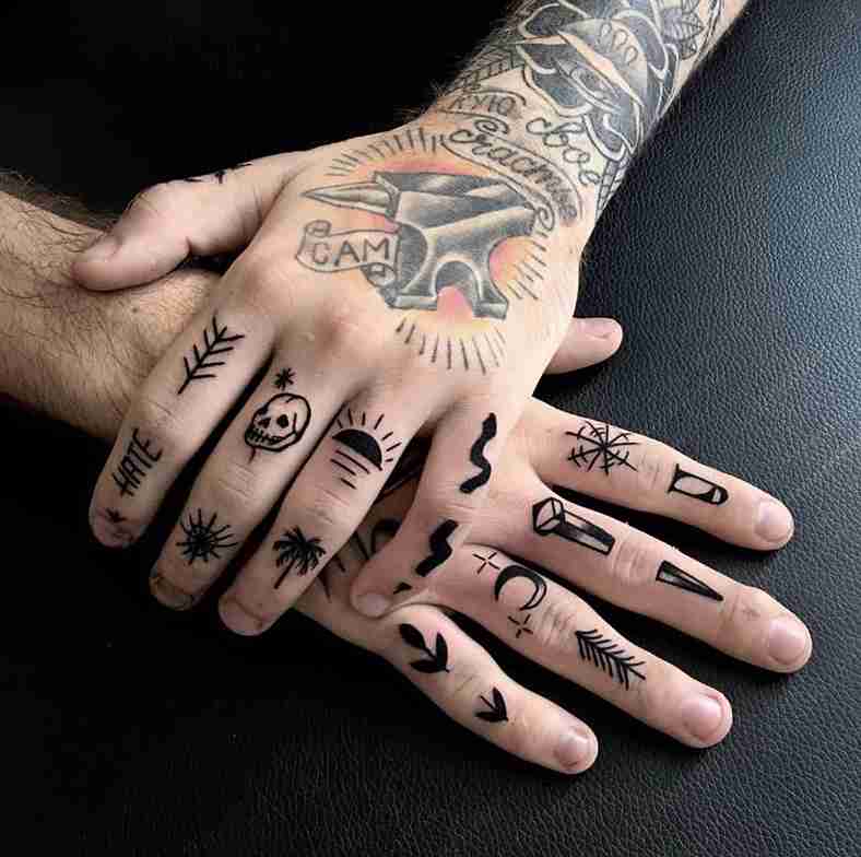 Woman showing finger tattoos with minimalist design
