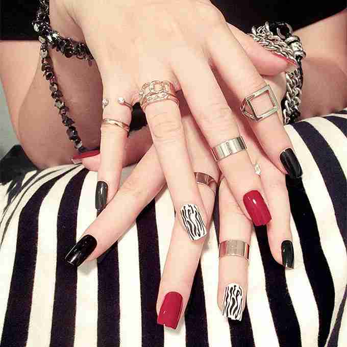 Woman showing finger tattoos with minimalist design