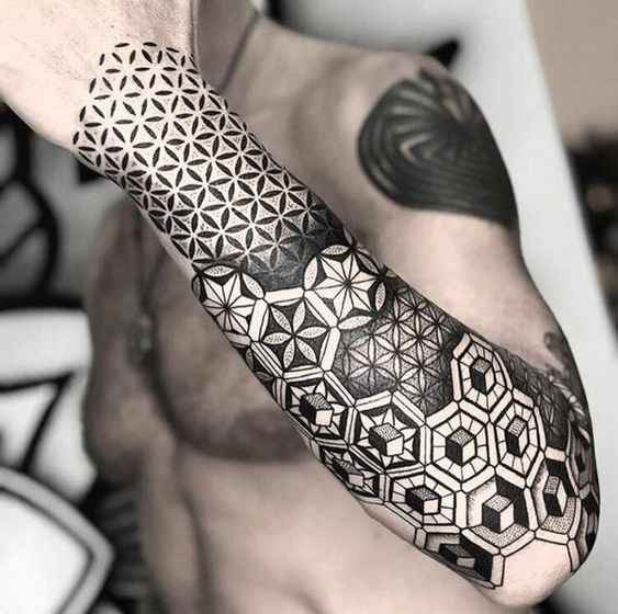Geometric tattoo sleeve design on a man’s arm while driving a car