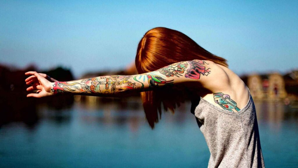 A tattoo model posing with detailed back tattoos